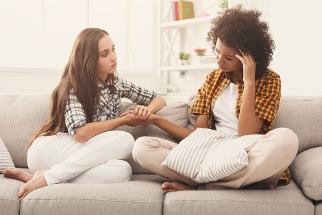 Teenage girl comforts her friend