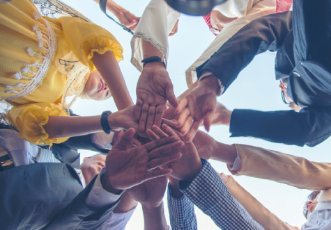 Team huddles with hands in center of circle